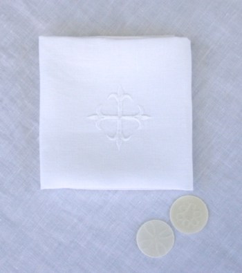 Purificator with embroidered cross and communion wafers from Altar Linens
